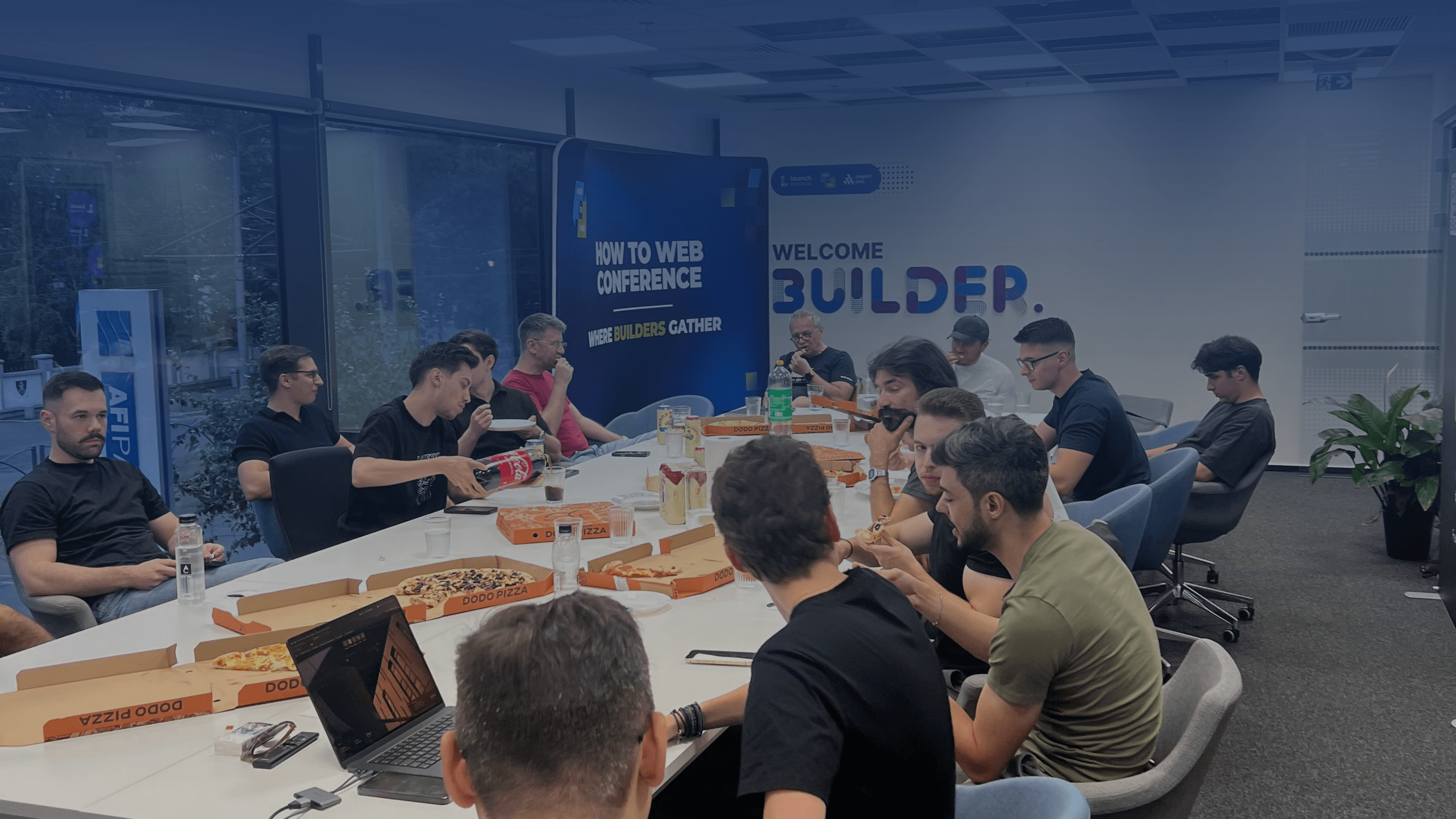 DevNights community members sharing pizza after an event